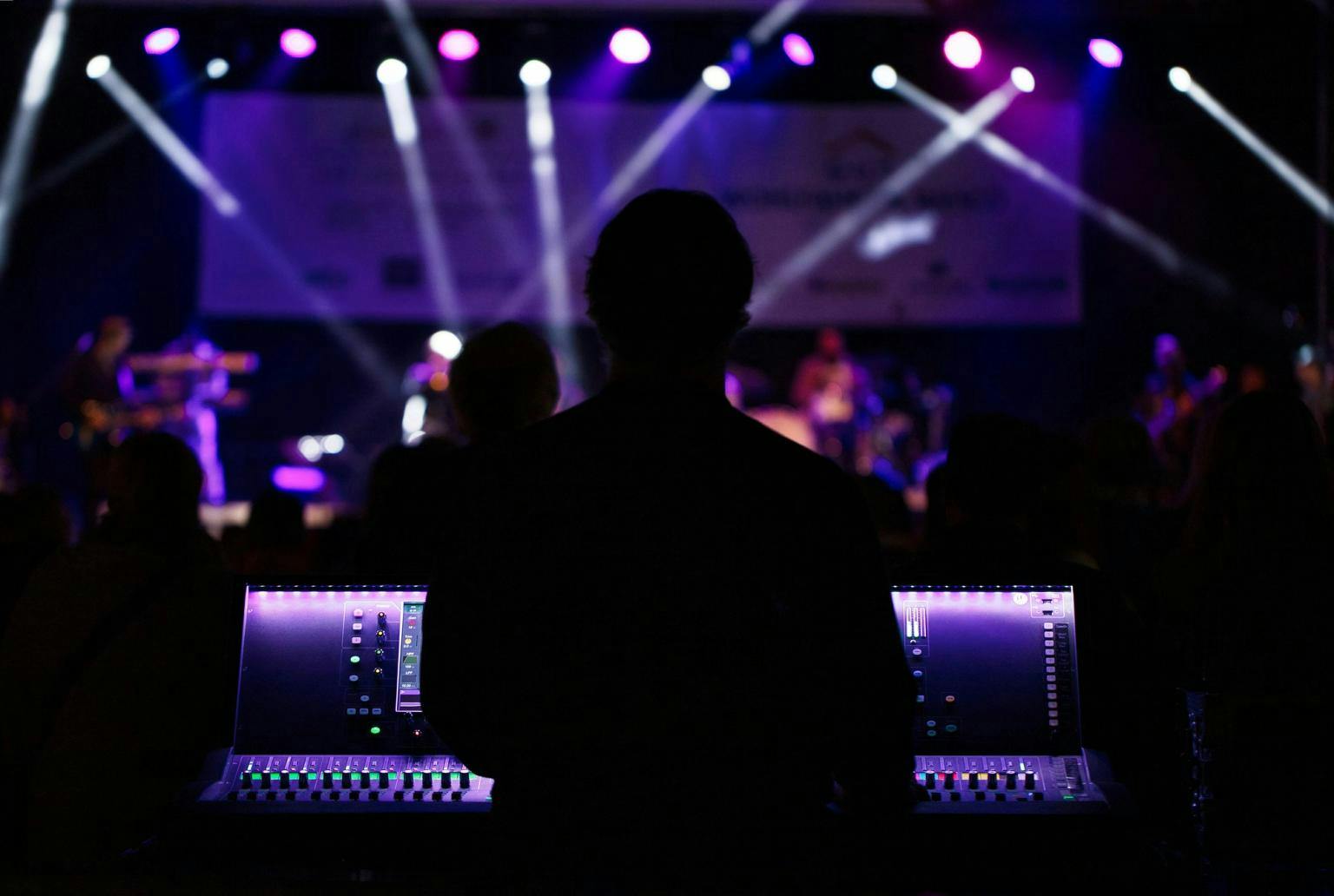 Stage lights sit ahead of a sound and light technicians desk 