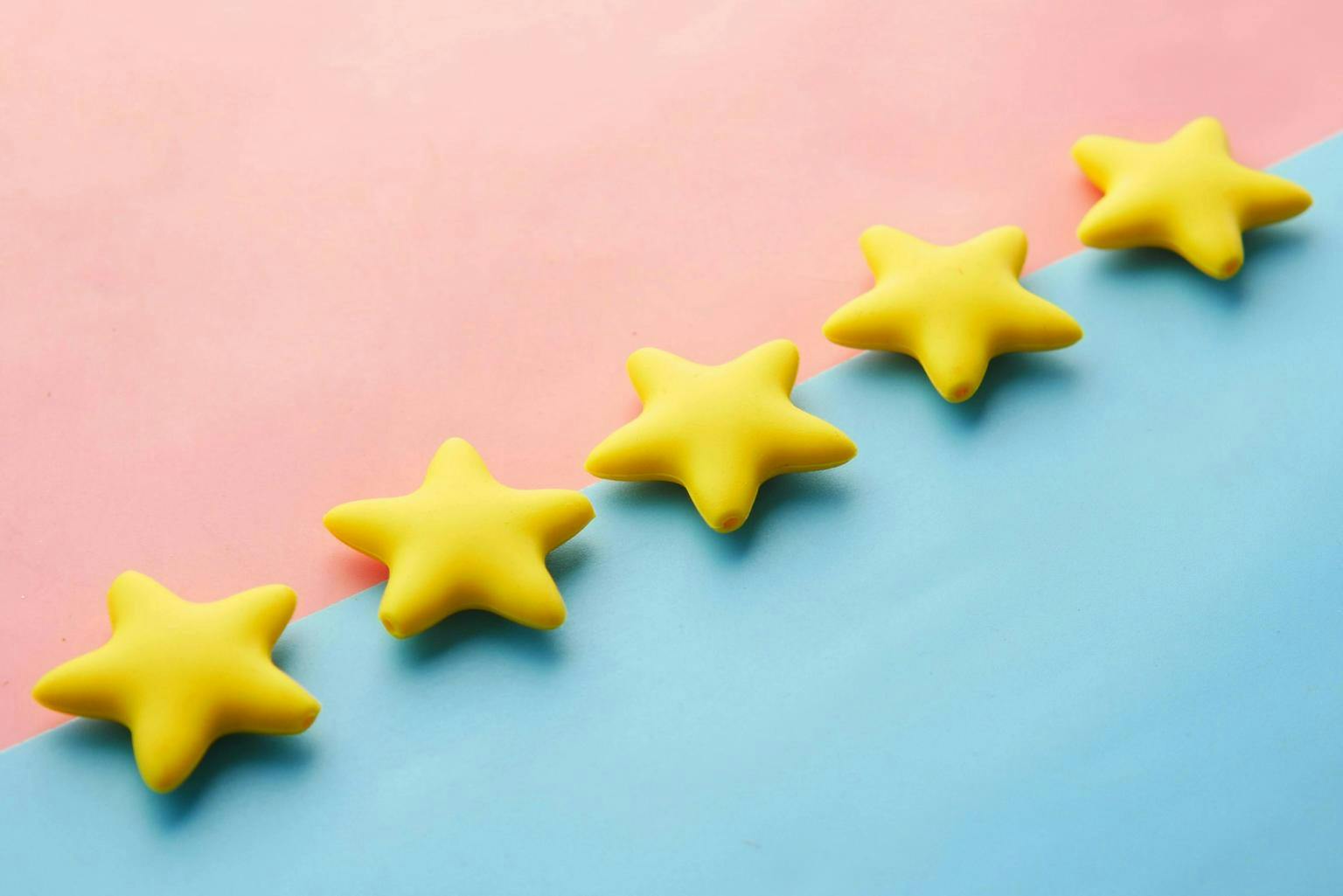 A row of gold stars on a pink and blue background
