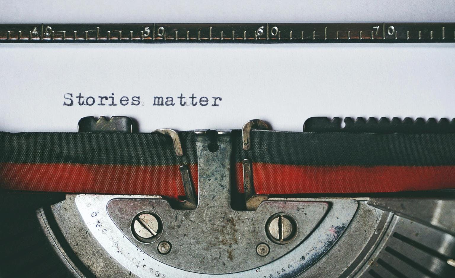 Close up for a typewriter, with the words 'Stories matter' op a page