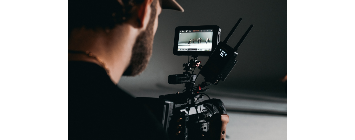 Video producer filming a dance class (photo by KAL VISUALS on Unsplash)