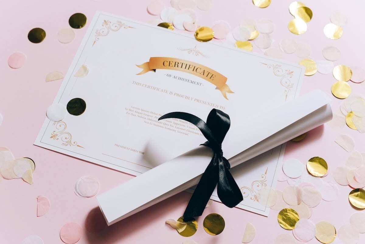 Certificate sites on table with scroll and gold confetti